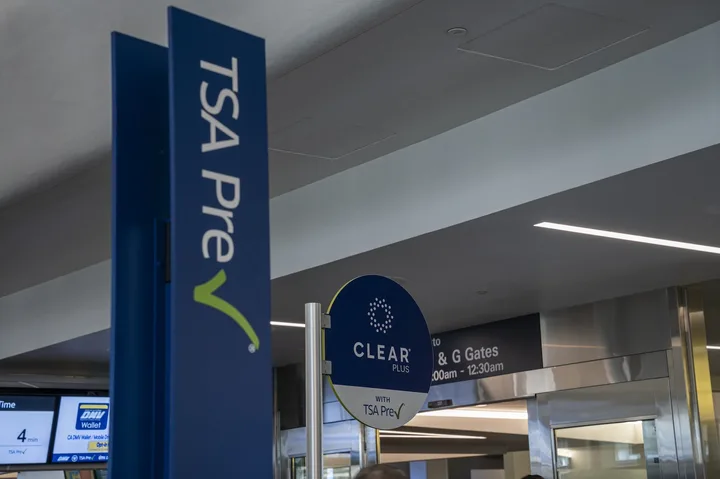 TSA PreCheck and CLEAR Plus signage side by side at an airport security checkpoint.
