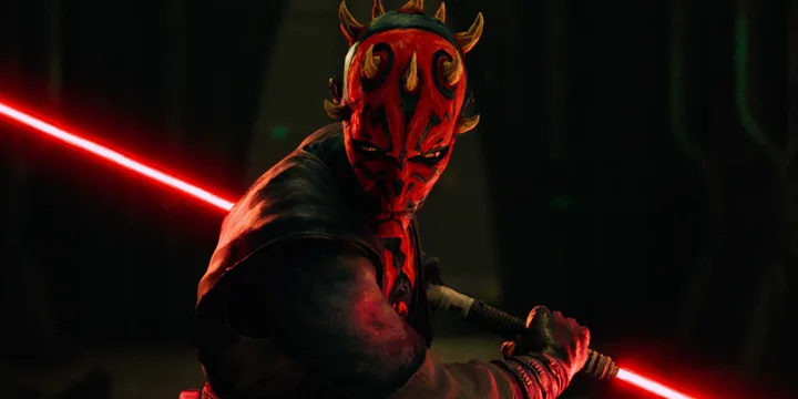 Darth Maul in combat stance wielding a red double-bladed lightsaber in a dark forest setting.