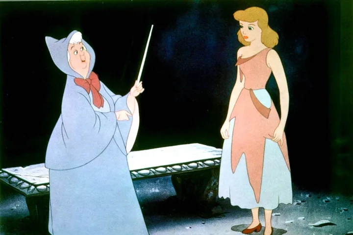 Animated Fairy Godmother pointing a wand at Cinderella in her torn dress in the 1950 Disney film.