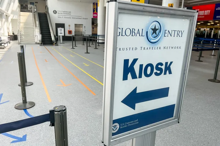 Global Entry Kiosk directional sign inside JFK International Airport's customs area.
