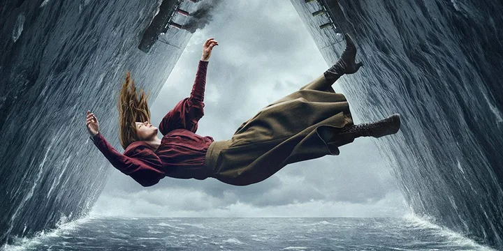 A person in period clothing falls dramatically between towering walls of water near a ship.