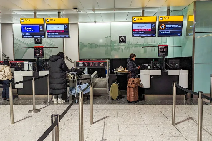 Ethiopian Airlines business class check-in desks D45-D47 at Heathrow with two passengers.