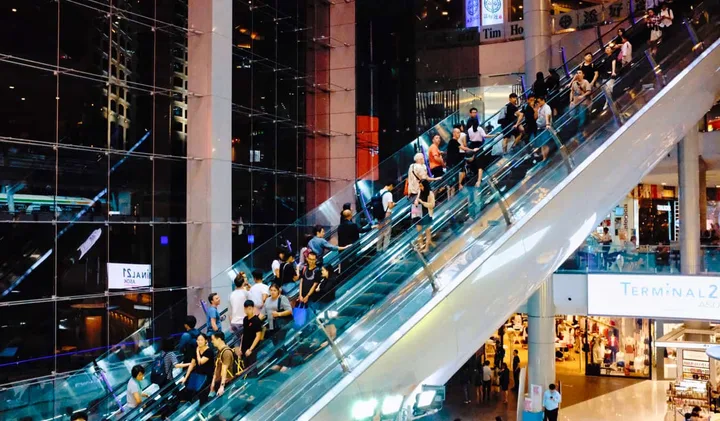 Crowded escalators inside a large modern shopping mall labeled Terminal 21.