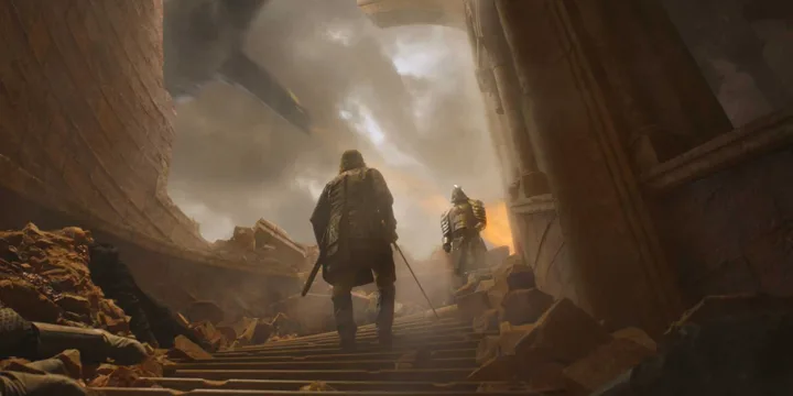 Two cloaked figures climbing rubble-strewn stairs in a dark, dramatic fantasy battle scene.