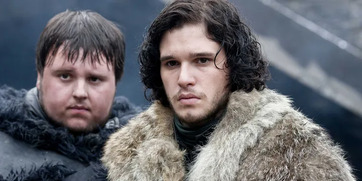 Two men in heavy fur and black Night's Watch cloaks looking forward with serious expressions.
