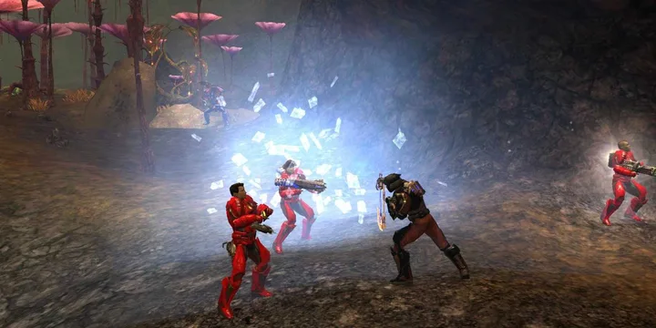 Red-armored soldiers battle a lone warrior in a dark alien cave with glowing crystals.