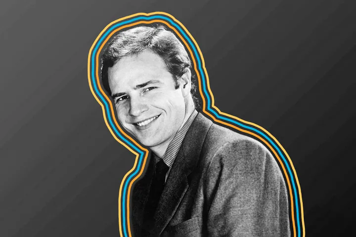 Black and white portrait of a smiling young man in a suit with colorful neon outline graphic effect.